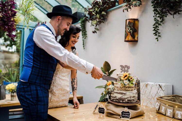 Cutting of the cake for this Cheltenham Wedding at The Storyteller Restaurant, Cheltenham
