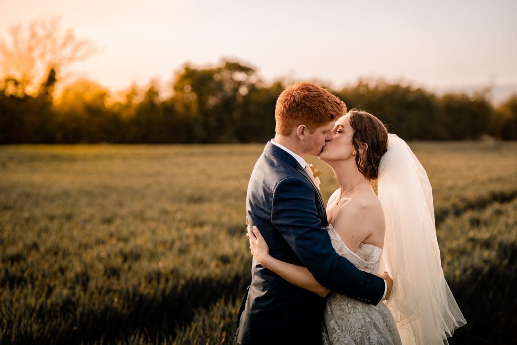 Newlywed couple portrait shoot in the Cotswolds Fields, during sunset.