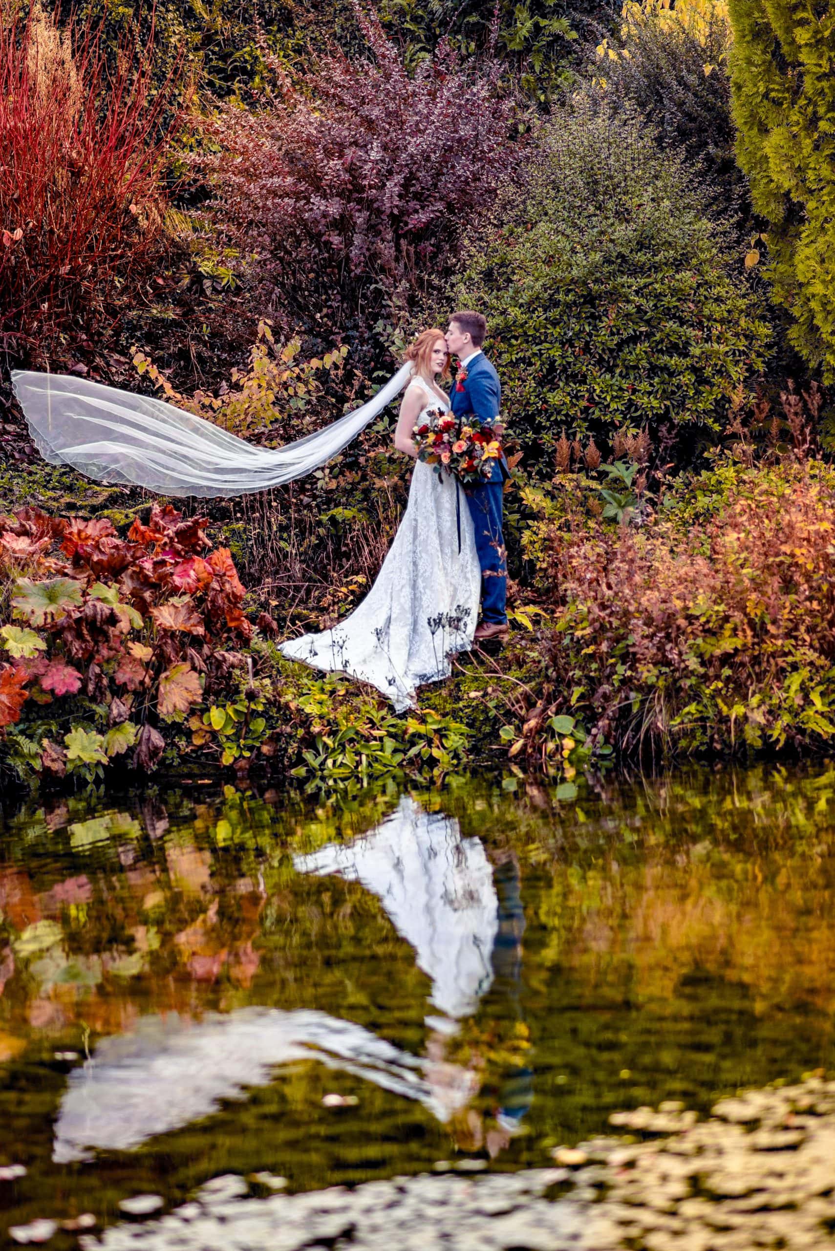 Reflective shot across the Autumnal themed lake of Barn at Upcote's fantastic secret garden.