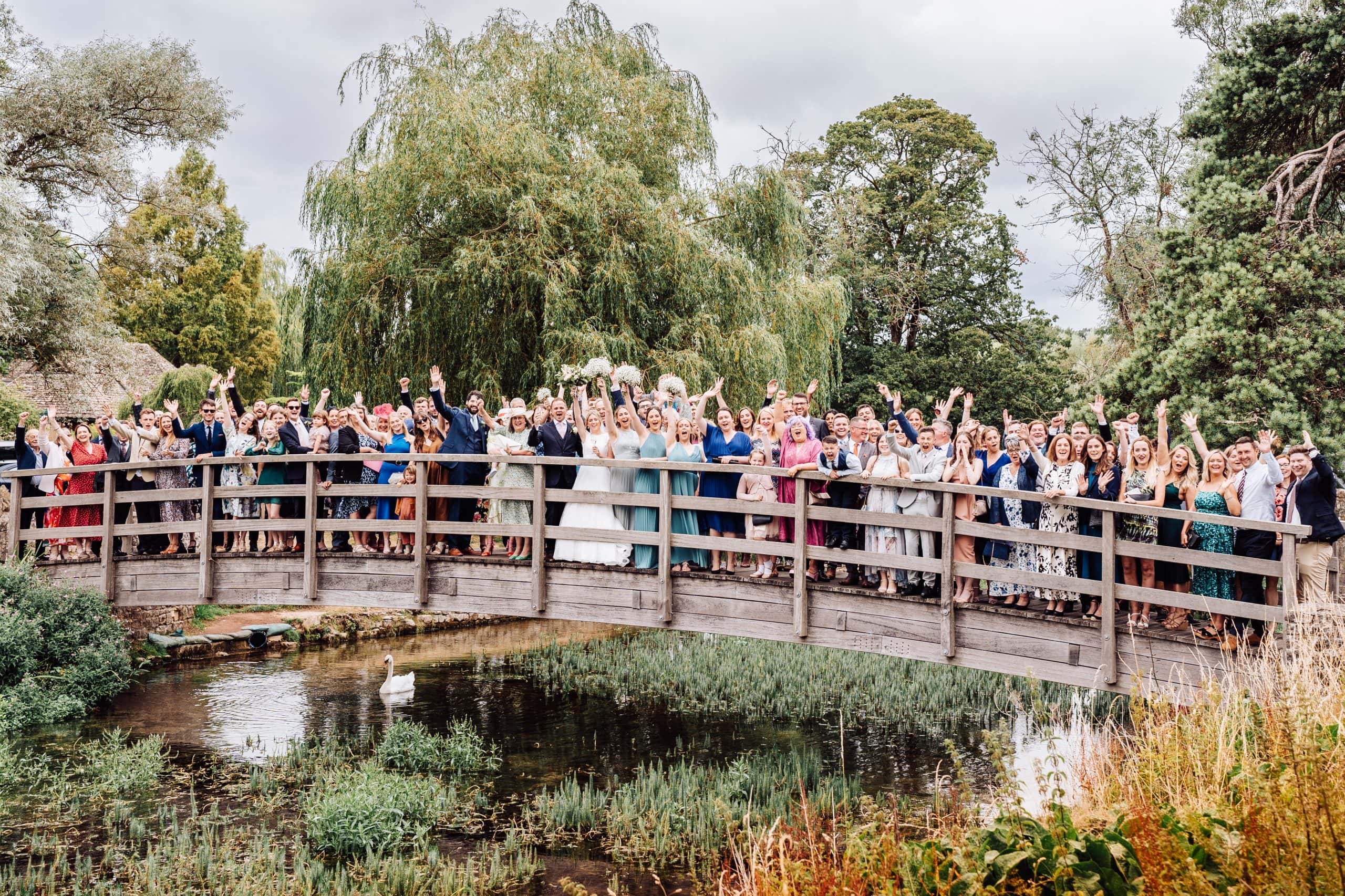 Group shot at a wedding at The Swan Hotel Bibury captured by Cotswolds wedding photographer Pedge Photography