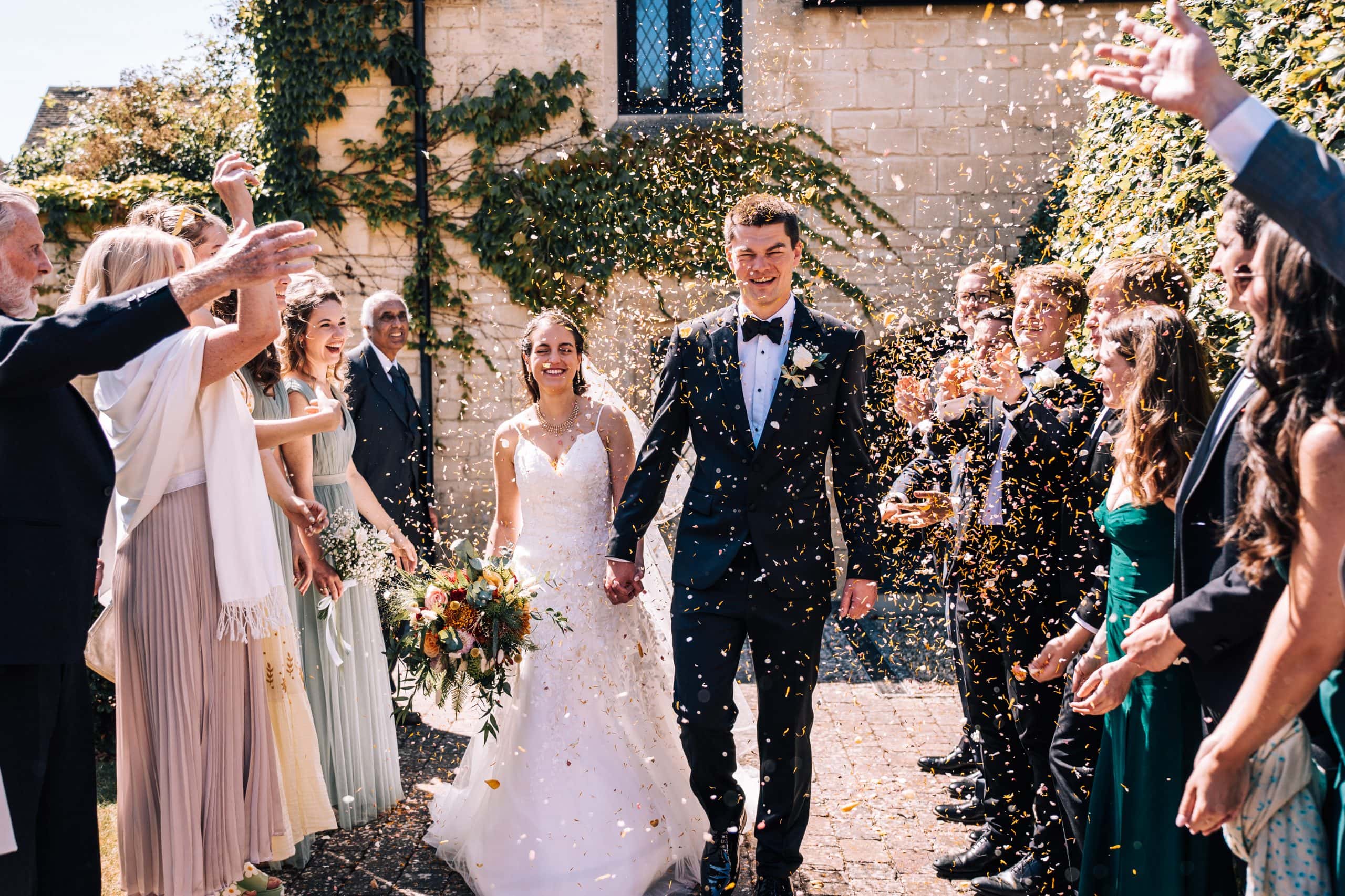 Major throwing of confetti over the bride and groom at Ellenborough Park in Cheltenham