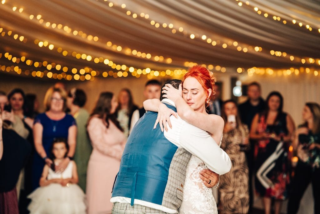 Bride and Groom embrace for an emotional first dance captured by Pedge Photography at Stanbrook Abbey Hotel