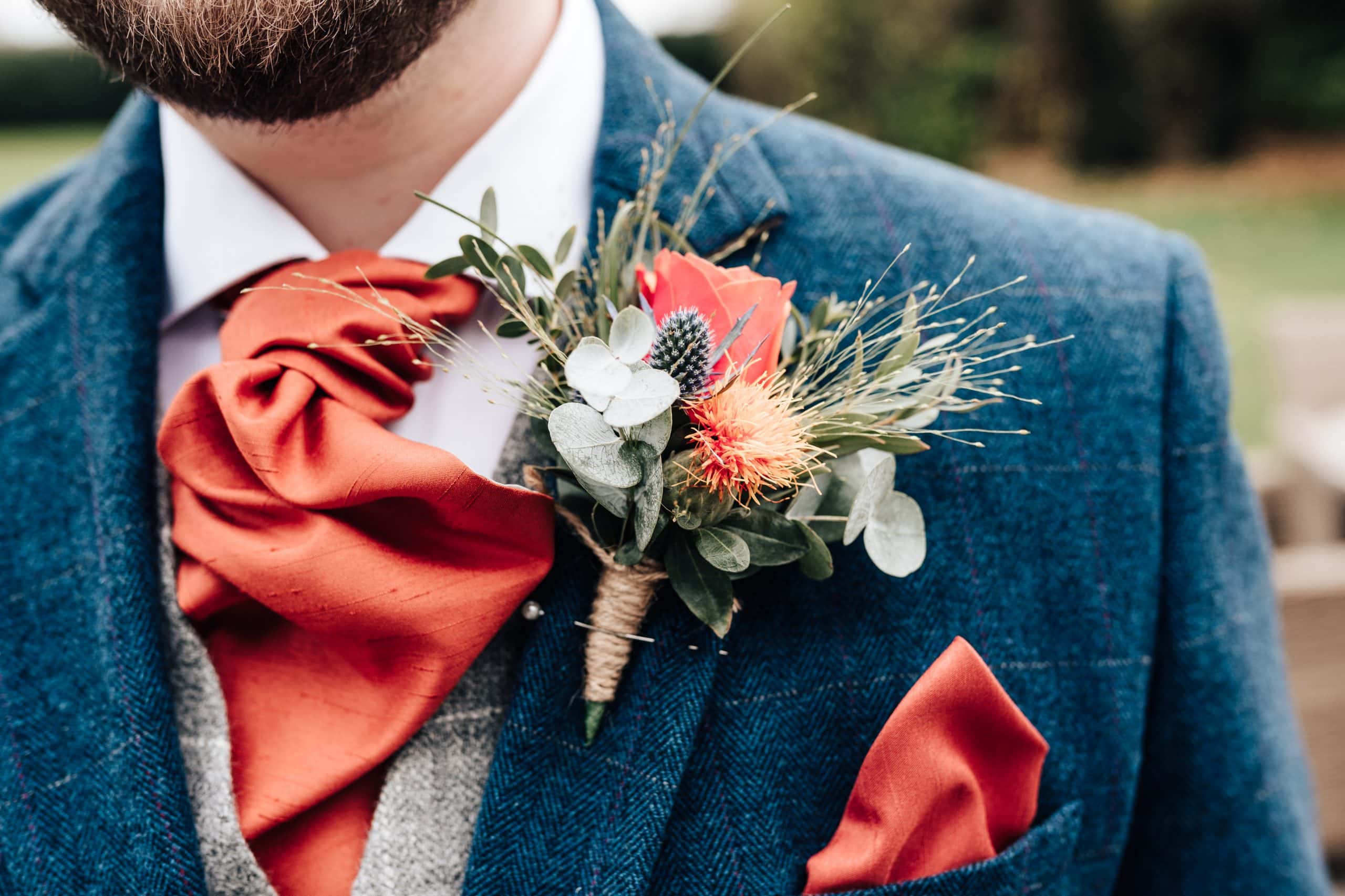 Close up of gorgeous floral autumnal buttonhole for the groom