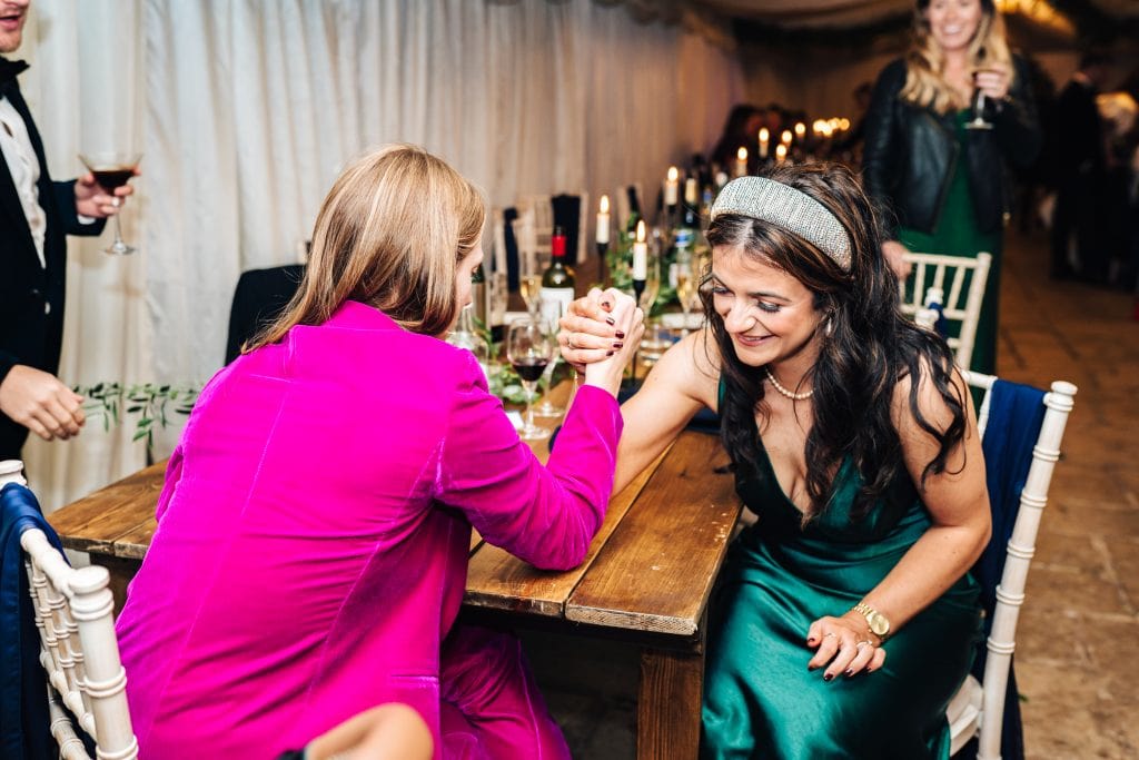 A spot of arm wrestling at a wedding! Not your every day expectation. Do you wonder who won? As the photographer, I know, but I'll let you try and figure it out.