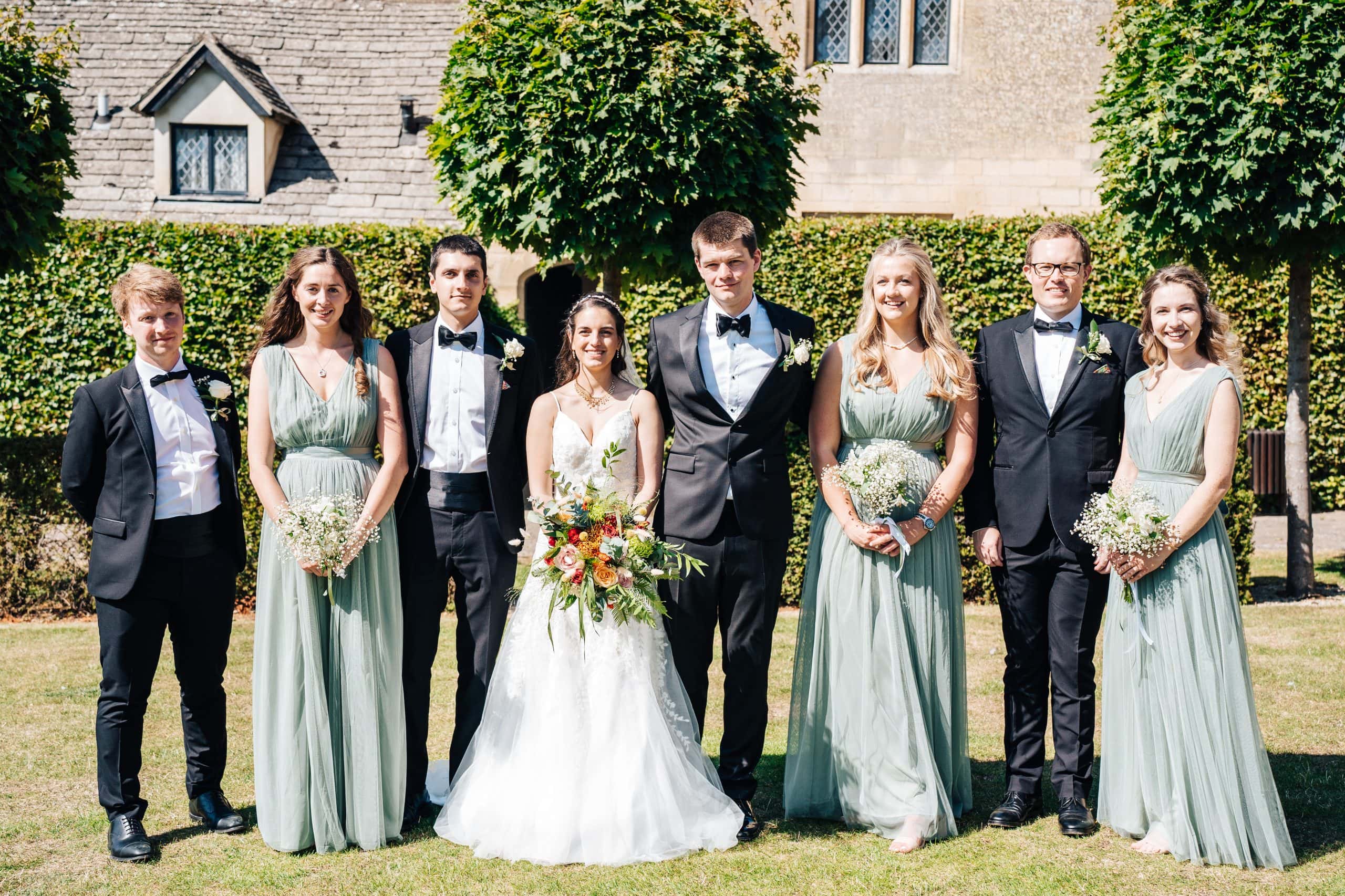 A wedding family portrait shot on the lawn outside the dining hall at Ellenborough Park Hotel, Cheltenham
