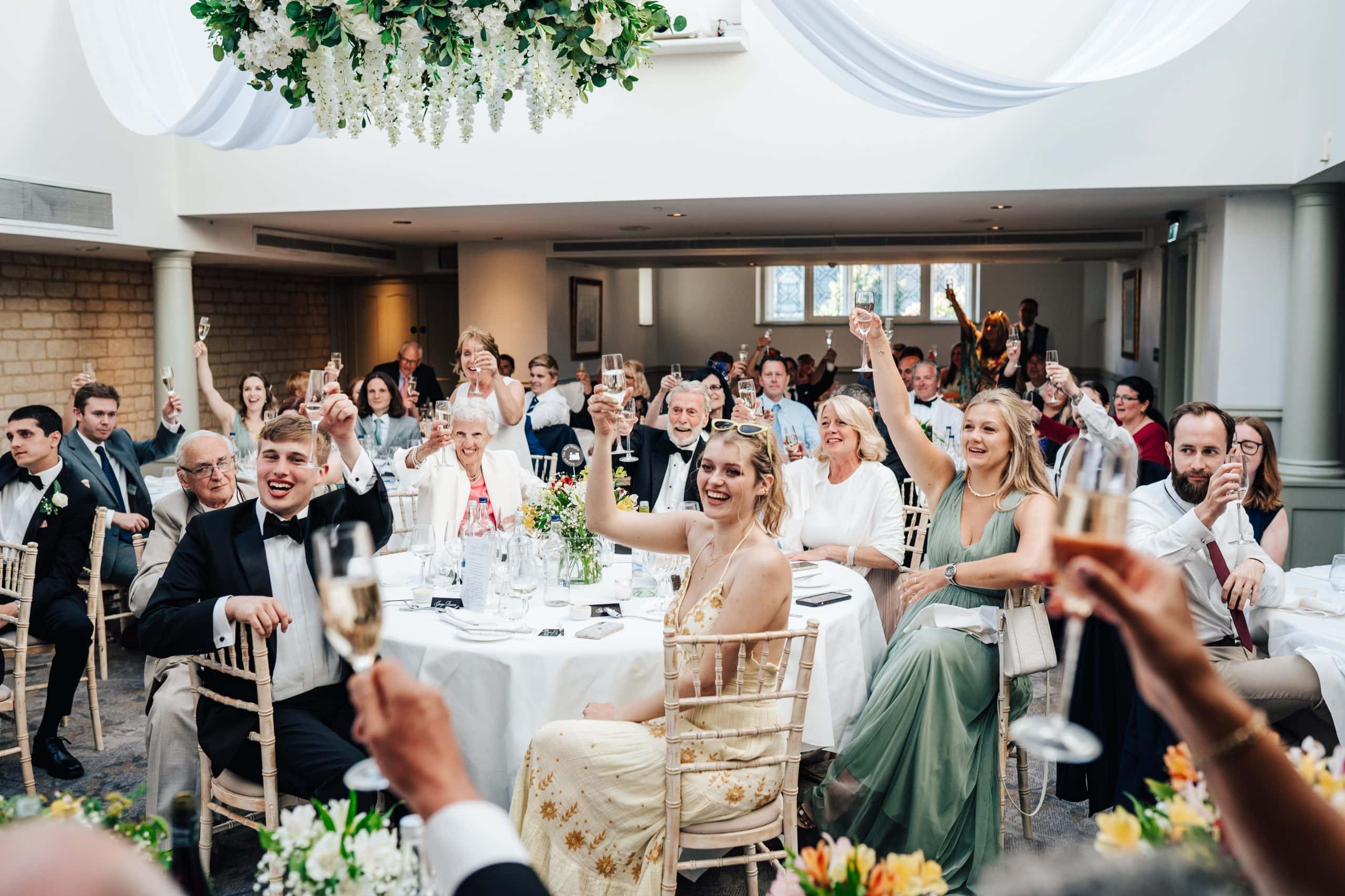 As the speeches end, the wedding party raise their glasses for a toast to celebrate this gorgeous wedding at Ellenborough Park Hotel