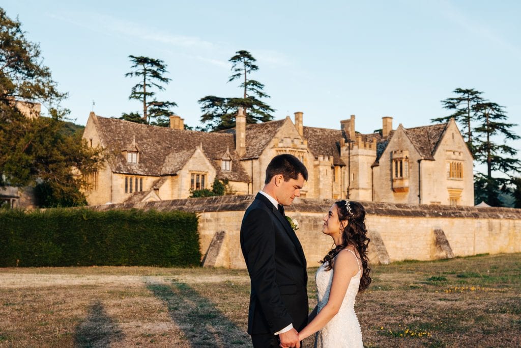 Married in the Cotswolds. Couple pose outside their cotswolds wedding venue, Ellenborough Park hotel, Cheltenham.