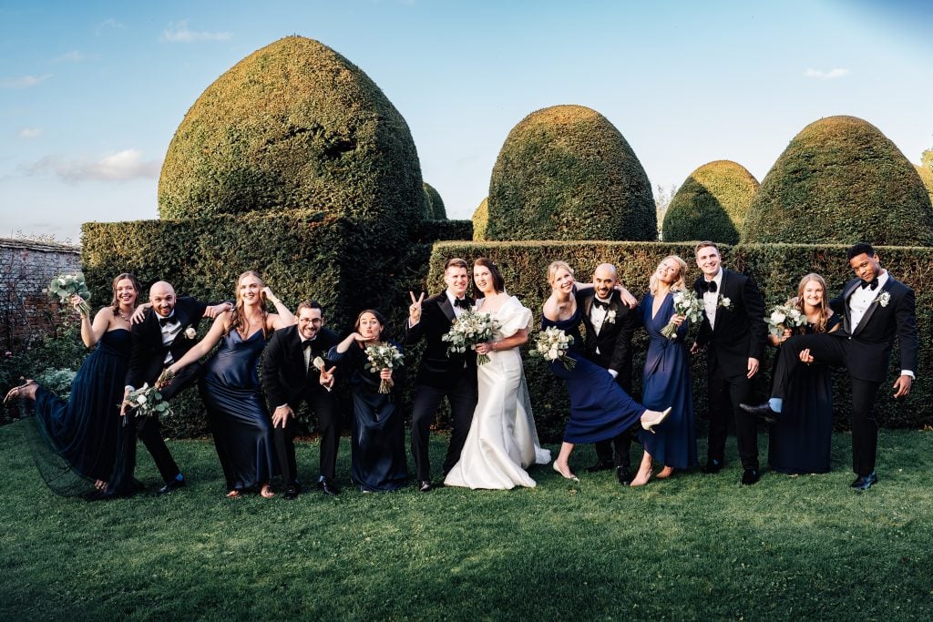 Formal group shot goes informal with laughs and funny posing at this Birtsmorton Court wedding captured by Pedge Photography