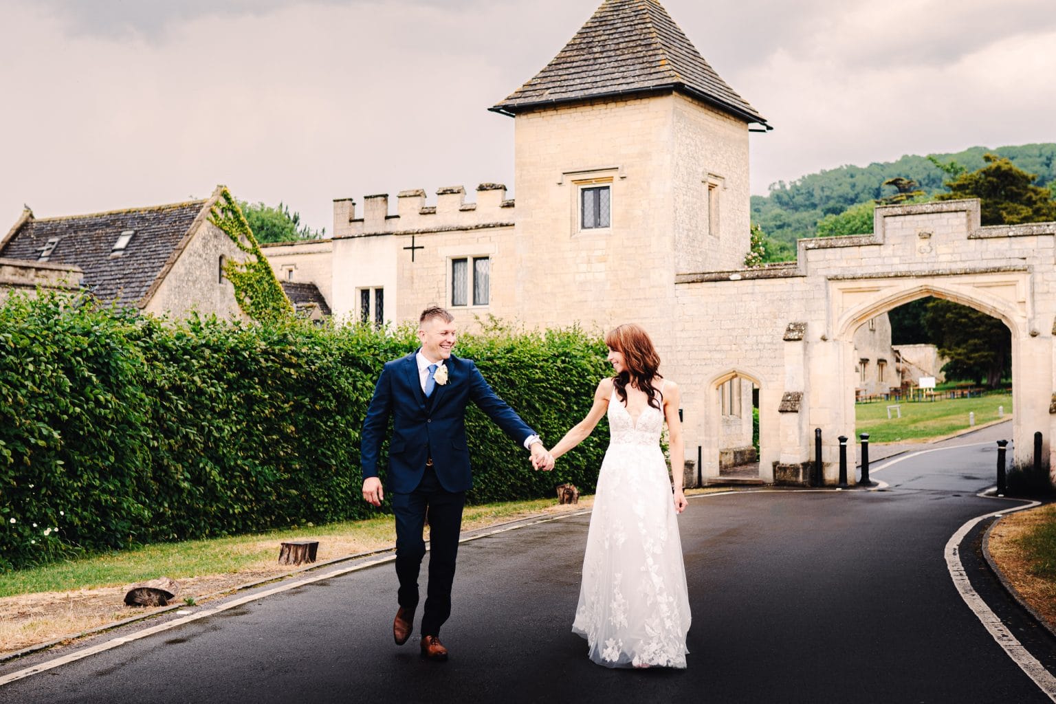 Wedding photographer Ellenborough Park Hotel captures this married couple walking hand in hand in this summertime wedding.